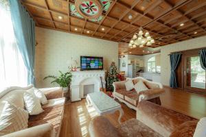 a living room with a couch and a fireplace at Mây Hoa Tiên Relax - Villa in Xuan An