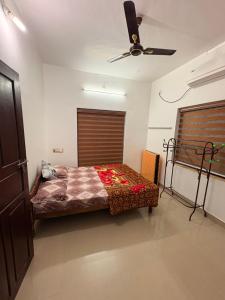 a bedroom with a bed and a ceiling fan at MOM'S VILLA in Nedumbassery +46 photos