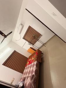 a room with two windows and a bed in a room at Moms Villa in Nedumbassery