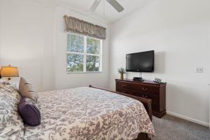 a bedroom with a bed and a flat screen tv at St Pete Vista Verde East 3 223 Spectacular Unit in Point Brittany