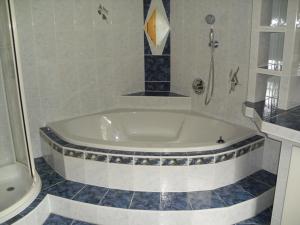 y baño con ducha y bañera blanca. en Nagelehof 3, en Ainet 38 fotos más