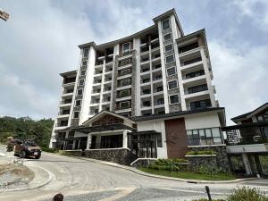 a large building with a car parked in front of it at The Banyan Rest in Balibaguhan