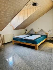 a bed in a room with a wooden ceiling at Ferienwohnung Ambiente - 3 Zimmer in Bad Säckingen