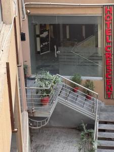 a building with a bunch of potted plants in the doorway at Crescent Hotel in Peshawar +40 photos