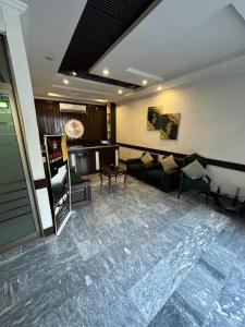 a living room with couches and a couch in a room at Crescent Hotel in Peshawar
