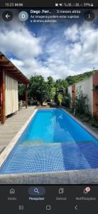 a picture of a swimming pool in a screenshot of a website at pousada essência in Paraty