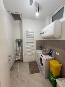 a laundry room with a washing machine and a sink at Maison Rovaga in Ispica