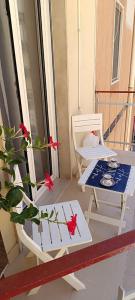 a table and a chair on a balcony with a plant at HOME SWEET HOME Casa vacanze e affitti brevi in Trani