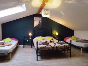a bedroom with two beds and a blue wall at La pointe du Chay in Le Pavé