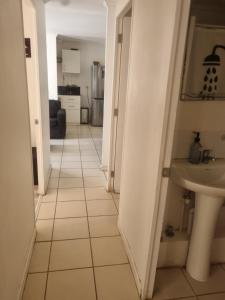 a hallway with a bathroom and a sink in a room at Departamento elsa ramitez in Ovalle