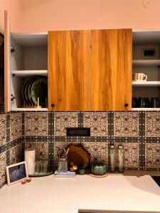 a kitchen with wooden cabinets and a counter top at Terra Cottage in Jāmb +1 photo