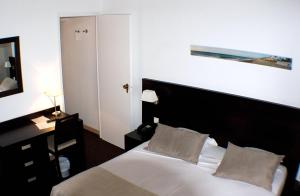 Postel nebo postele na pokoji v ubytování Hôtel Comté de Nice