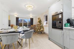 a kitchen and dining room with a christmas tree at Mystic Heights- Wyndale Signature Stays in Worcester
