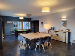 a dining room with a table and some chairs at Villa de l'Olivier in Aytré +13 photos
