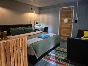 a bedroom with a large bed and a couch at Baan Koody Hostel in Ko Kut +8 photos
