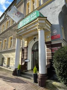 a building with a sign on the front of it at Centrum Kołobrzeg in Kołobrzeg