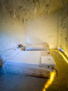 a bedroom with two beds in a room with lights at El Dorado Camp in Siwa