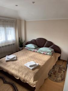 Un dormitorio con una cama con dos toallas encima. en ЯВіС, en Mamaivci Village 8 fotos más