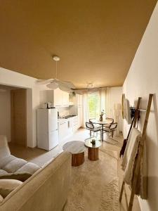 a living room with a couch and a table at Beautiful 2 bedroom apartment with pool in Saint Florent in Oletta