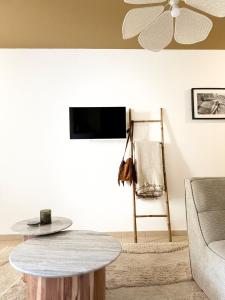 a living room with a table and a ceiling fan at Beautiful 2 bedroom apartment with pool in Saint Florent in Oletta