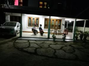ein Motorrad, das nachts vor einem Haus geparkt ist in der Unterkunft Diyatalawa Mountain Holiday Resorts in Diyatalawa