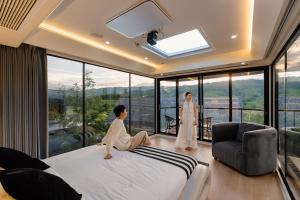 a man sitting on a bed in a bedroom with a woman at PARACH RESORT KHAOKHo in Khao Kho +60 photos