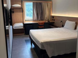 Ένα ή περισσότερα κρεβάτια σε δωμάτιο στο Ibis Joao Pessoa Praia