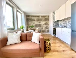 a living room with a couch and a kitchen at VIVA - Rooftop Terrace View Flat in Porto +6 photos