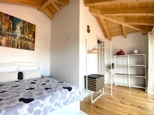 a bedroom with a bed and a painting on the wall at VIVA - Rooftop Terrace View Flat in Porto