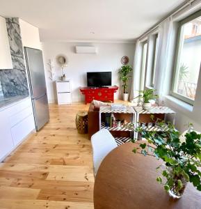 a living room with a table and a tv at VIVA - Rooftop Terrace View Flat in Porto