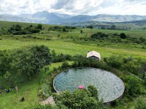 an overhead view of a swimming pool in a field at AfriCamps Champagne Valley in Champagne Valley
