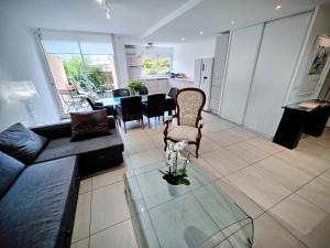 a living room with a couch and a glass table at Terrasse de Malissol in Vienne