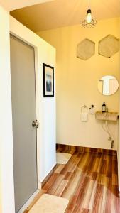 a room with a white door and a wooden floor at Coco villa in Pālghar