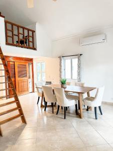 a dining room with a wooden table and chairs at Beautiful second floor apartment with loft 5D in El Francés