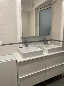 a bathroom with two sinks and a mirror at Villa Malù in Lignano Sabbiadoro