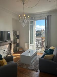 a living room with a couch and a coffee table at L'observatoire in Le Havre