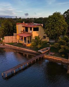 a house with a dock next to a body of water at Casa Vidão da Lagoa in Maricá +17 photos