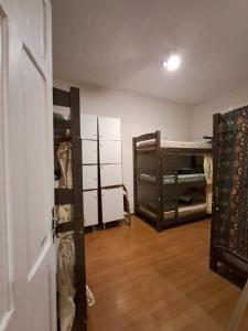 a room with two bunk beds and a door at Pousada Hostel Trilhas e Rotas in Sao Paulo +23 photos