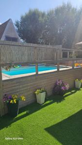 a backyard with a fence and a swimming pool at הבית בשביל הזהב in Caesarea