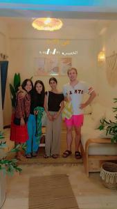 a group of people posing for a picture in a room at Shali Home in Siwa