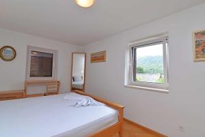 Postel nebo postele na pokoji v ubytování Villa Kaciol Veli Lošinj