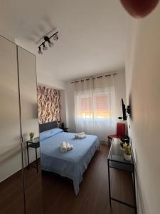a bedroom with a blue bed and a mirror at Casa Angelina in Mirto