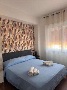 a bedroom with two towels on a bed at Casa Angelina in Mirto