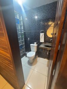 a bathroom with a toilet and a sink at Pousada Beleleuss in Jericoacoara +27 photos