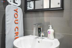 a bathroom with a sink and a bottle of toothpaste at Bright & Modern Room in Brixton - Shared Bathroom in London