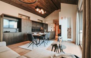 a living room with a couch and a table at Alpin Chalet Dachsteinhaus in Ramsau am Dachstein