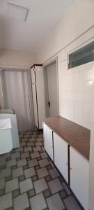 a kitchen with a counter and a door in a room at Quartos em Maceio à 100m da praia in Maceió +38 photos