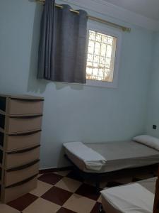 Ένα ή περισσότερα κρεβάτια σε δωμάτιο στο agadir location vacance aourir plage