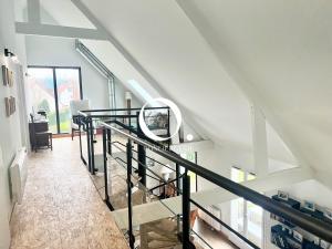 a staircase in a house with a mirror at COC - Le Gulistan in Wissant