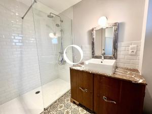 a bathroom with a sink and a shower with a mirror at COC - Le Gulistan in Wissant +41 photos
